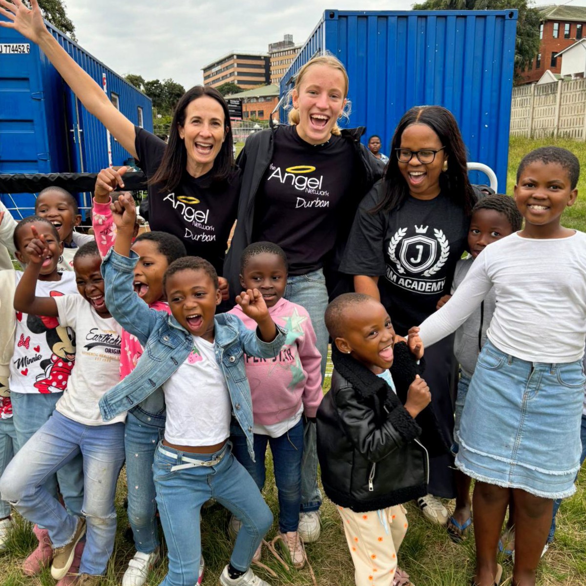 Excited children and volunteers